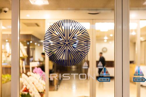 a sign on the window of a store at Natural Hot Spring Ariston Hotel Oita in Oita
