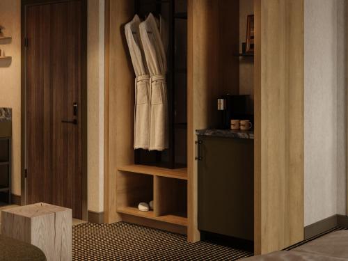 a room with a closet with a robe on the door at The Kenrick Hotel in Banff
