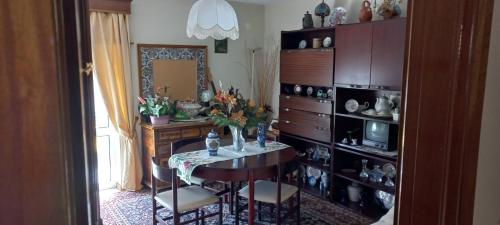 a dining room with a table and a mirror at CasaPinto in Castro Daire