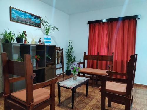a living room with chairs and a table and a tv at Casa Pía Deluxe in Valladolid