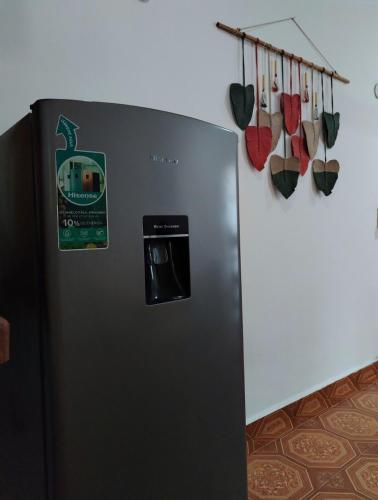 a black refrigerator in a kitchen with some shoes at Casa Pía Deluxe in Valladolid
