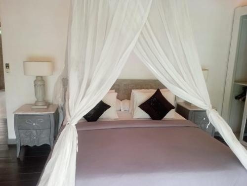 En eller flere senge i et værelse på Villa Akasha