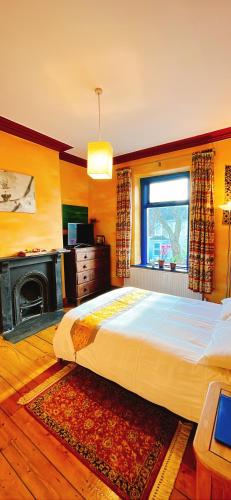 a bedroom with a large bed and a window at Funky Urban Jungle in Cardiff
