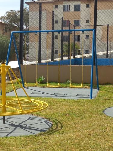 a yellow and blue playground equipment in a yard at Mi casa su casa 5 in Londrina