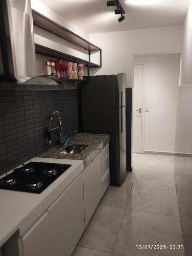 a kitchen with a sink and a counter top at Mi casa su casa 5 in Londrina