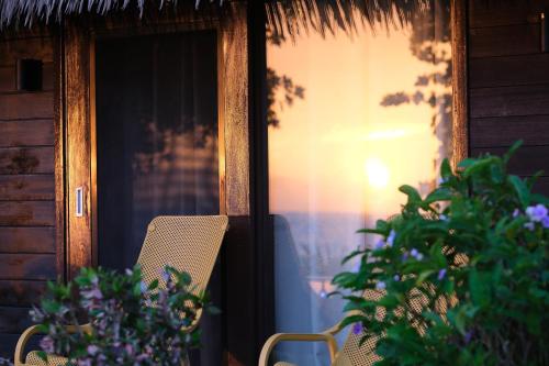 a porch with a chair and some plants and a window at Yatule Resort & Spa in Natadola