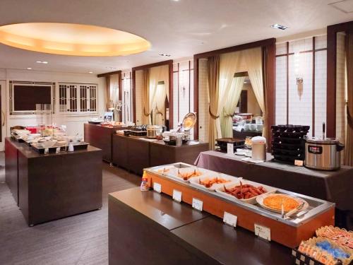 a restaurant with a buffet line with food on display at Hotel Grand Terrace Toyama in Toyama