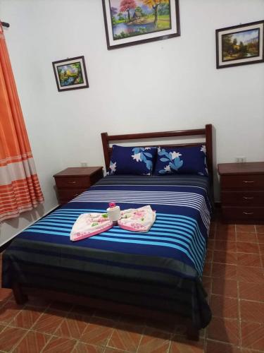 a bedroom with a bed with two towels on it at Hotel Lider in Santa Cruz de la Sierra