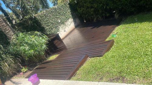 a wooden walkway in the grass in a yard at Punta Chica - Alojamiento Premium in Victoria