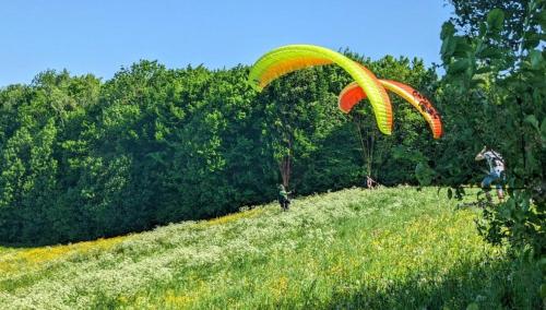 a person flying a parachute over a field at Attractive 2 room apartment south of Munich in Ottobrunn