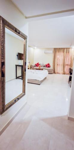 a mirror on a wall in a living room at Palm's Hotel Club in Erfoud