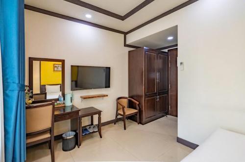 a hotel room with a desk and a television at La Serena Boutique Hotel in Ho Chi Minh City