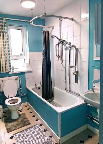 a bathroom with a tub and a toilet and a sink at YPCC Accommodations in Bradford