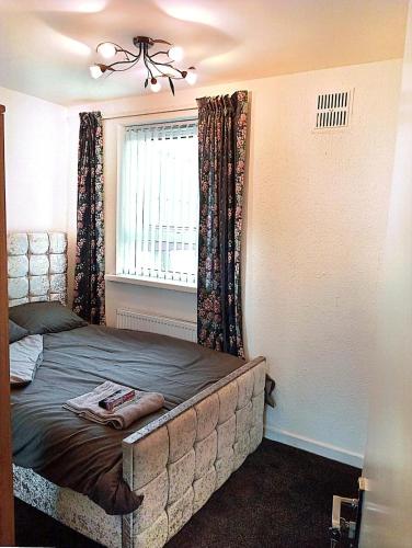 a bedroom with a bed in a room with a window at YPCC Accommodations in Bradford