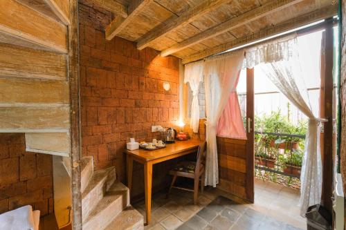 a small room with a wooden table and a window at Djajanti House in Semarang