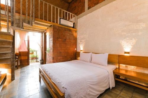 a bedroom with a white bed in a room at Djajanti House in Semarang