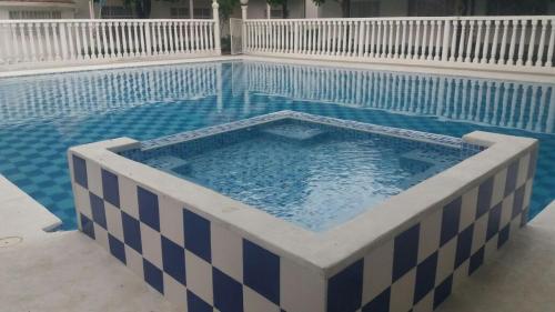a pool with a blue and white checkered swimming pool at Alquiler cabaña Melgar in Melgar