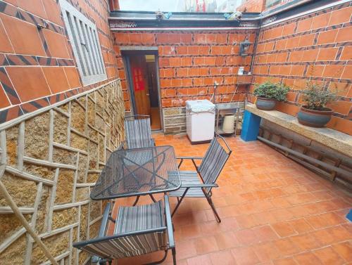 a patio with two chairs and a table and a heater at 湖峰古厝民宿 in Jinning