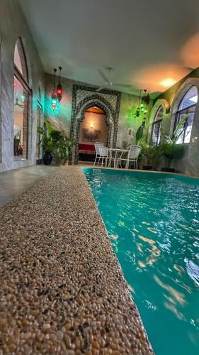 an indoor swimming pool with a large blue swimming pool at The Manzil Janda Baik in Bentong