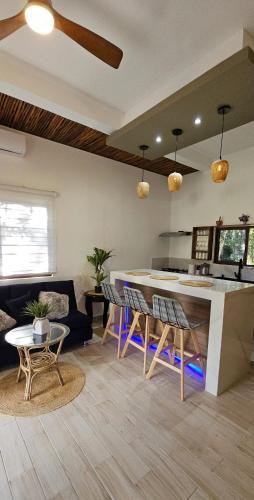 a kitchen and living room with a bar and chairs at aldea isla sagrada in Cozumel