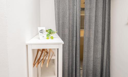 a white side table with a gray curtain at Central Room 128L in Palermo