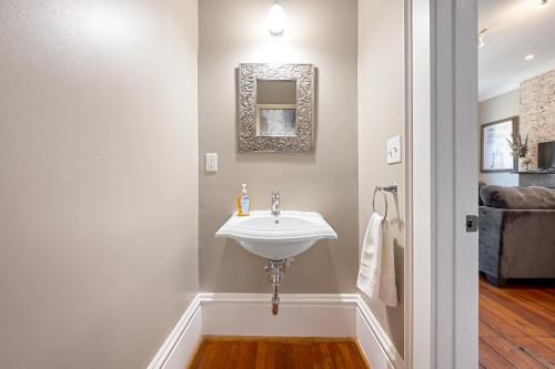 a bathroom with a white sink and a mirror at No Car Needed King Bed Balcony Abercorn And York-2 in Savannah