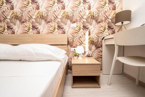 a bedroom with a bed and a desk with a chair at Central Room 128L in Palermo