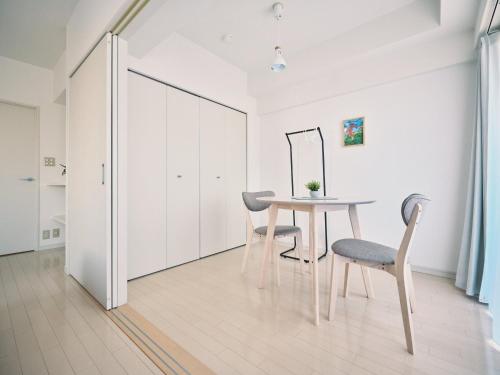 a dining room with a table and two chairs at vetta kumamoto shinyashiki 701 in Kumamoto
