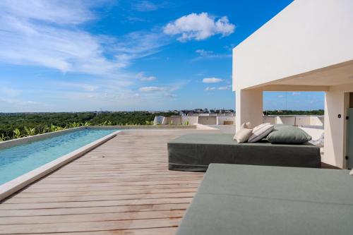 a bedroom with a bed next to a swimming pool at Luxury Jungle Condos by Casago in Tulum