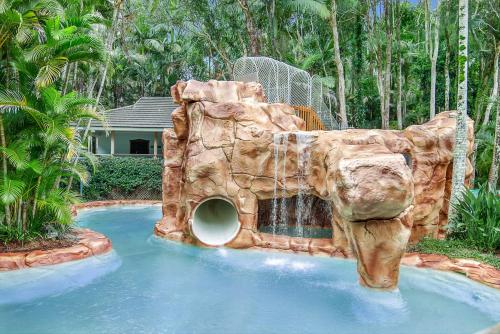 a water slide in a pool in a backyard at Villa 3 By The Sea in Coffs Harbour