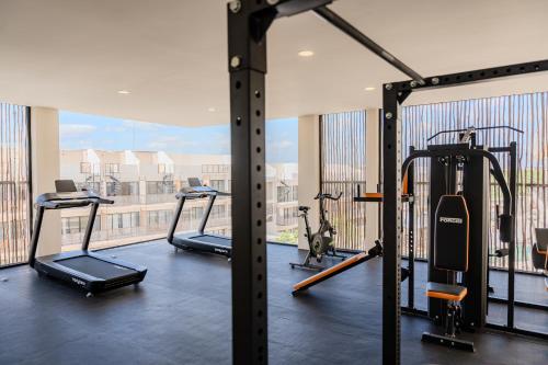 a gym with treadmills and ellipticals in a building at Luxury Jungle Condos by Casago in Tulum