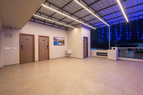 a large room with blue lights on the ceiling at Maple Comfort in Visakhapatnam
