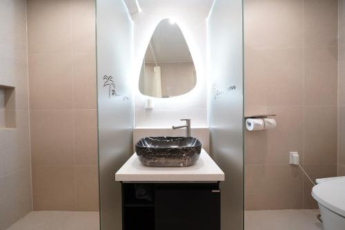 a bathroom with a sink and a mirror at Gyeongju Poolvilla Runtoyou in Gyeongju