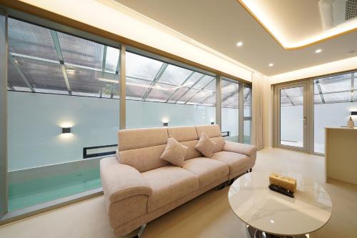 a living room with a couch and a glass table at Gyeongju Poolvilla Runtoyou in Gyeongju