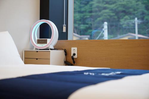 a bedroom with a bed and a mirror on a dresser at Gyeongju Poolvilla Runtoyou in Gyeongju