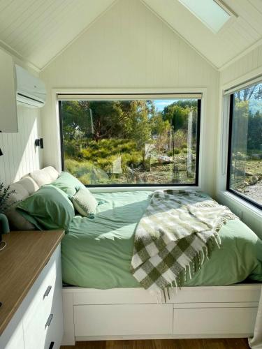 a bed in a small room with a window at Beachside Nature Retreat on Kangaroo Island in Island Beach