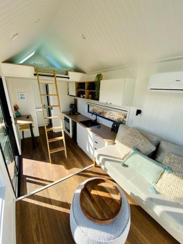 a living room with a couch and a table at Beachside Nature Retreat on Kangaroo Island in Island Beach
