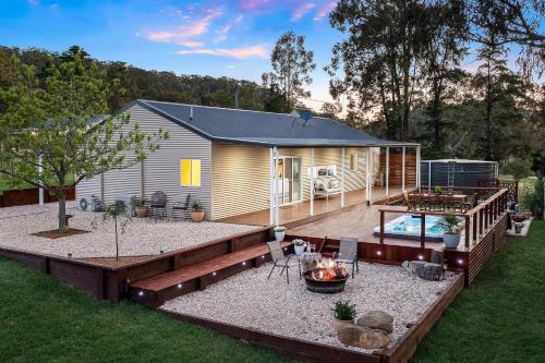 a backyard with a tiny house and a pool at Little Corner Farm in Broke