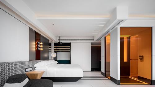 a hotel room with a bed and a hallway at Maiyue Hotel-Chongqing Jiefangbei Chaotianmen in Chongqing
