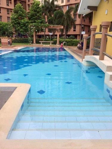a large blue swimming pool in a building at Avida Condo near NAIA in Manila