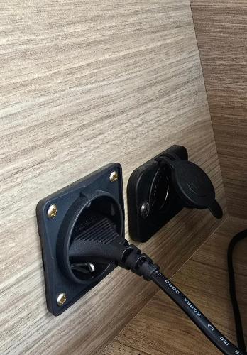 a black cordless vacuum cleaner sitting on a wooden floor at Caravan with Driving services in the surrounding area in Hwaseong