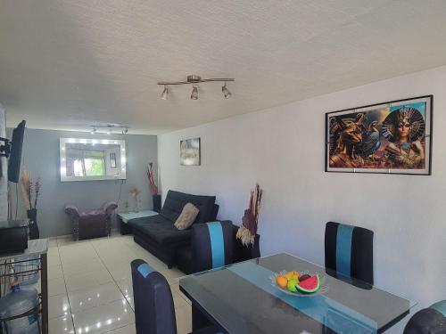 a living room with a table and a couch at Aguilas Room 1 in Guadalajara