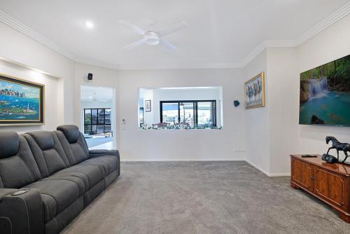 a living room with a couch and a table at Canal living 3 bed or 1 bed with Pool in Redcliffe