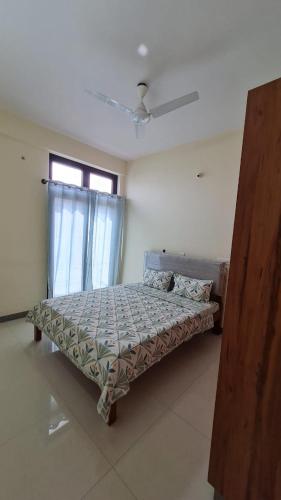 a bedroom with a bed in a room with a window at HSR layout Abode 2 in Bangalore