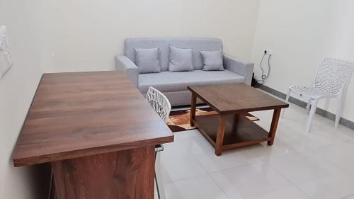 a living room with a couch and a table at HSR layout Abode 2 in Bangalore
