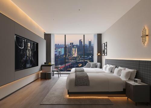 a bedroom with a large white bed and a large window at Rigel Hotel-Chongqing Jiefangbei Chaotianmen in Chongqing