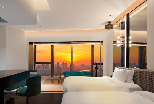 a bedroom with a bed and a view of a city at Rigel Hotel-Chongqing Jiefangbei Chaotianmen in Chongqing