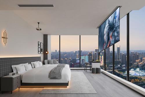 a hotel room with a large bed and a large tv at Rigel Hotel-Chongqing Jiefangbei Chaotianmen in Chongqing