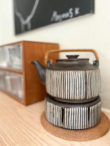 a tea kettle sitting on top of a table at Idyllic Holiday Home In Ebeltofts Nature in Femmøller
