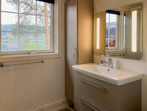 a bathroom with a sink and a mirror and a window at Unique Setting And Silence On Private Island in Byglandsfjord